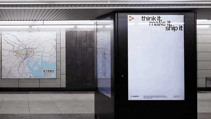 A digital Replit ad in a subway station.